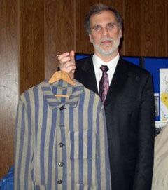 Marvin Antman Marvin Antman of East Brunswick holds the concentration camp uniform worn by his father, Herman, at Bergen-Belsen. The uniform was among artifacts and photos on display during the program.