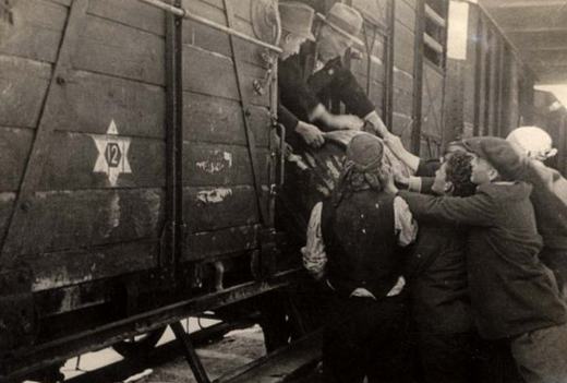 Jews in 'New' Bulgaria being loaded into box cars after being rounded up and incarserated by Bulgarian police and soliders