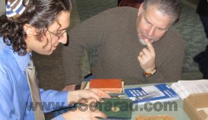 naar Dr. Devin Naar, left, and community member Rick LaMarche, examining Ladino documents at the Purim Bazaar at Congregation Ezra Bessaroth in Seattle, Washington, March 2012.. Photo by JTA Photo Service