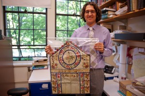 Devin Naar holds an 1897 wedding contract from Tekirdag, Turkey, written in Hebrew and Aramaic. Many Sephardic Jews in Seattle trace their roots to Tekirdag and other parts of the former Ottoman Empire. Naar is gathering examples of Sephardic Jewish books and documents in Hebrew, Turkish and especially Ladino, for the Sephardic Studies Initiative and archive. Document courtesy of Rabbi Solomon Maimon. Photo: Mary Levin