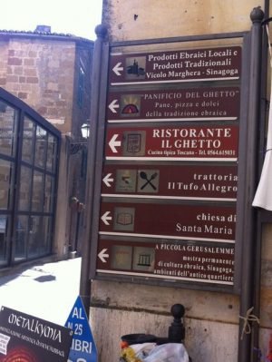 A sign in Pitigliano points towards "A Piccola Gerusalemme," or "Little Jerusalem," as well as several restaurants located in the old ghetto. Sylvia Poggioli/NPR
