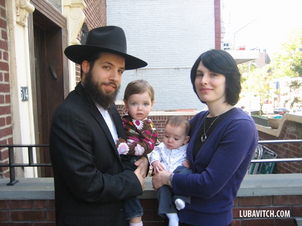 Rabbi Eli and Raizel Rosenfeld with their two children, Mushka, age one and a half, and three-month old Menachem Mendel.