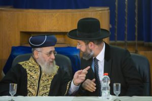 Click photo to download. Caption: Sephardic Chief Rabbi of Israel Yitzchak Yosef (left) and Ashkenazi Chief Rabbi of Israel David Lau (right) speak at a rabbinic ordination ceremony of the Israeli Chief Rabbinate in Jerusalem on Sept. 4, 2014. Yosef recently issued a call to action for the Sephardic Jewish community to join Ashkenazim in embracing pre-marriage genetic testing. Credit: Yonatan Sindel/Flash90.