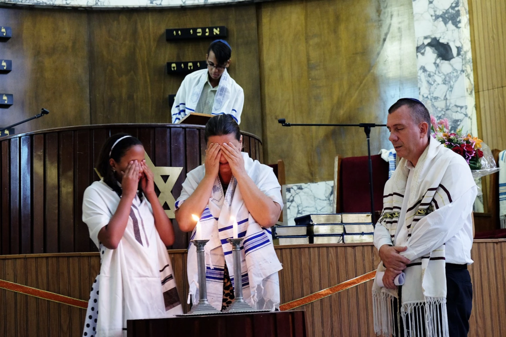 Parents participate in their daughter’s bat mitzvah inside the Beth Shalom synagogue, Aug. 29, 2015, Havana. (Jonathan Alpeyrie)