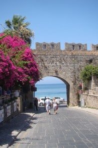 Tourists walking through the old city walls of Rhodes near the Square of Jewish Martyrs. (Gavin Rabinowitz/JTA)