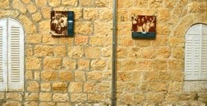 Top: The photograph of the Navon family during a vacation in Tel Aviv in 1926 can be seen on a facade on Hermon Street. Bottom: Photographs of several of the former residents give the neighborhood a human touch. 