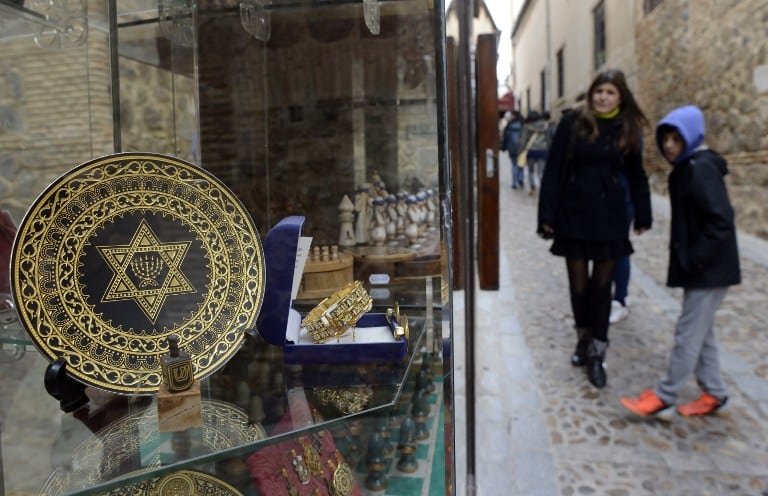 People stand near a gift shop in the old Jewish Quarters of Toledo, Spain on February 27, 2014. (photo credit: AFP/Gerard Julien)