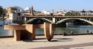 Incluso los sevillanos y sevillanos más fervientes pueden no conocer el Monumento de la Tolerancia por este nombre. Sin embargo, si les preguntáramos por una vanguardista escultura ubicada en el Muelle de la Sal, junto al Puente de Triana, posiblemente sabrán de qué estamos hablando. En lo relativo a su significado, eso ya es otra historia que venimos a desgranar. El Monumento a la Tolerancia es una obra del pintor y escultor Eduardo Chillida, que se financió a través de la Fundación Amigos de Sefarad. Se inauguró el 1 de abril en 1992, coincidiendo con la inauguración de la Exposición Universal de Sevilla. Al evento acudieron importantes personalidades como el presidente de Israel, Jaim Herzog, su esposa Aura, el Nobel de la Paz Elie Wiesel y el propio escultor.