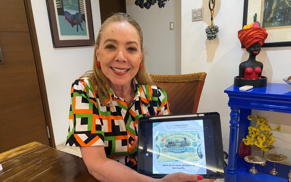 Luz Marina Forero muestra un billete antiguo en su iPad: los judíos sefardíes de Curazao fundaron el primer banco de Colombia. estatua Marius Bbraker